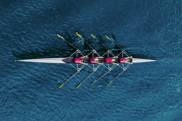 women's rowing team on blue water