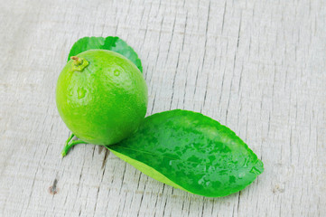 Lime and leaves on wood.