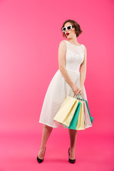 Wall Mural - Full length portrait of a surprised girl dressed in dress