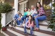 © Monkey Business - Multi Generation Family Sit On Steps Leading Up To House Porch