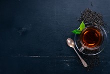 A Cup Of Black Tea On A Wooden Background. Top View. Copy Space.