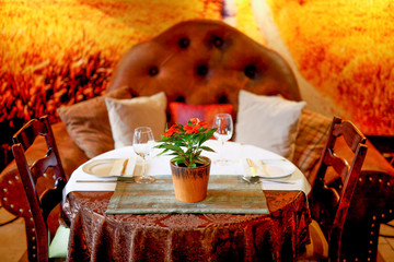 Table for two in luxury restaurant with modern sofa