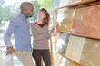© auremar - Man and woman looking at floor tiles