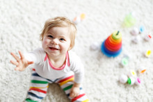 Adorable Cute Beautiful Little Baby Girl Playing With Educational Colorful Wooden Rainboy Toy Pyramid