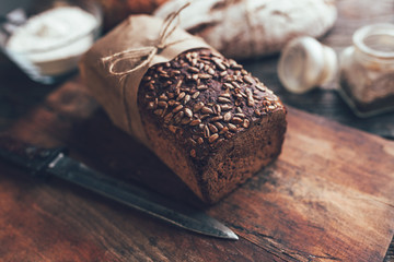 Wall Mural - Delicious fresh bread on wooden background