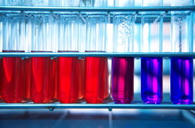 Red Purple Glass Test Tube In Metal Rack In Medical Biochemistry Science Laboratory Background