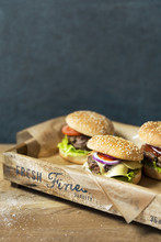 Three Hamburgers On Wooden Tray