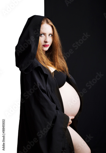 Beautiful Redhead Young Pregnant Woman In A Black Cloak With A Hood