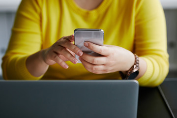 Wall Mural - woman with mobile phone and laptop in office