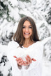 © Lazy_Bear - young beautiful woman in a white sweater is holding a heart from the snow