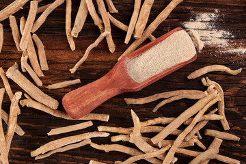 Wall Mural - Ashwagandha roots and powder in spoon.