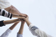 © chotiga - Teamwork group of young people putting their hands together for showing unity