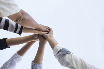 teamwork group of young people putting their hands together for showing unity