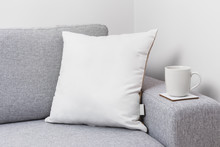 Blank White Pillow On A Couch With A Tea Cup.