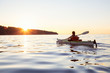 Adventure Girl kayaking on a sea kayak during a colorful and vibrant sunset. Taken near Jericho Beach, Vancouver,