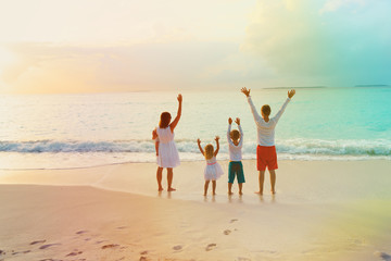 happy family with kids having fun at sunset