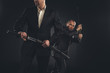 © LIGHTFIELD STUDIOS - two mature modern samurai with katanas isolated on black