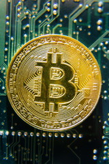 Wall Mural - golden bitcoin coin lying on green computer keyboard, cryptocurrency bubble investing concept