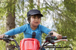 © Scandinav - Little boy with brown hair and cap sitting on motorcycleÂ 
