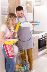 Wall Mural - Couple with clean plates from dishwasher