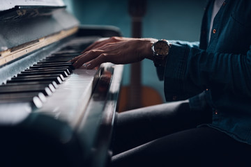 Woman seated at a piano playing music