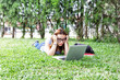 © jovannig - Teenager girl using laptop outdoor on a city park