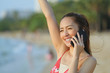 © etemwanich - beautiful girl happy talk receiving good news by stand on the beach in evening time