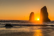 © ExploringandLiving - Beautiful sunset overlooking Haystack Rock in the Oregon Coast