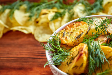 Wall Mural - Fried potatoes with salt, dill, spices on a wooden Board on brown background with copy space