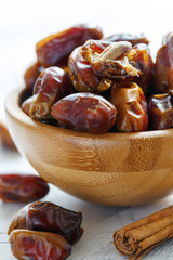 Wall Mural - Dried dates in a wooden bowl closeup.