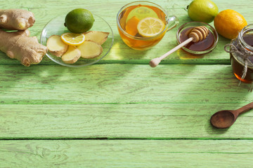 Wall Mural -  Ginger tea and ingredients on a  grunge wooden background