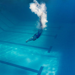 Sticker - underwater picture of young female swimmer exercising in swimming pool