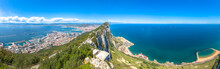 Panorama Of Top Of Gibraltar Rock, In Upper Rock Natural Reserve: On The Left Gibraltar Town And Bay, La Linea Town In Spain At The Far End, Mediterranean Sea On The Right. United Kingdom, Europe.