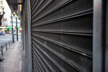 Metal gate protecting a store. Close shop.