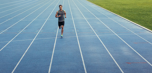 Wall Mural - sprinter running on track