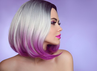 Wall Mural - Colorful dyed Ombre hair extensions. Fashion haircut. Beauty Model Girl blonde with short bob purple hairstyle isolated on purple background. Closeup woman portrait.