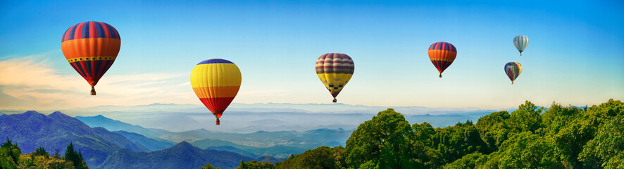 panorama of mountain with hot air balloons on morning at thailand.