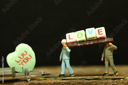 Construction Worker Figure Model Carrying Pieces Of Text Cube