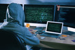 © Africa Studio - Man wearing hoodie hacking server in dark room