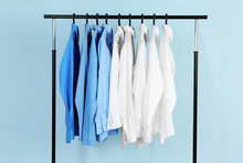 Clean Shirts Hanging On Rack In Laundry