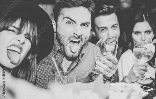 Friends having fun drinking cocktails and taking selfie in the bar - Young peopl Poster