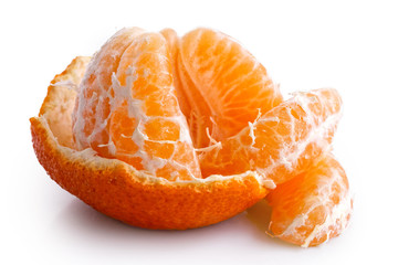 Poster - A half peeled mandarin split into segments isolated on white.