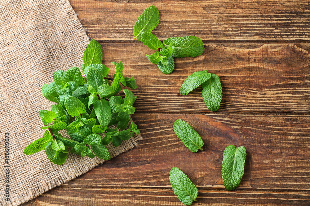Fresh lemon balm on wooden background, top view
