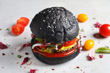 Poster - Tasty black burger on light background