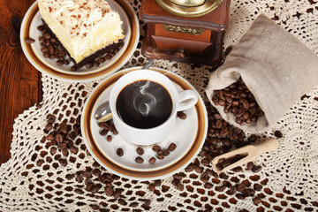 Wall Mural - black coffee in a cup with chocolate cake