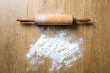 Concept of homemade cooking with rolling pin spread with flour