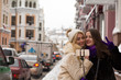 © vpavlyuk - Two positive girls friends taking a self portrait at the city using mobile phone