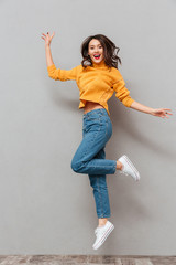 Wall Mural - Full length image of Pleased brunette woman in sweater