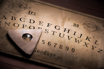 Talking board and planchette used on seances for communicating with the dead, high contrast image