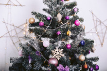 Christmas Tree With Decorative Toys And Garlands In The Background